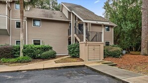 A multi-story apartment building with a covered front entrance, a small outdoor area with steps, and a parking lot in front. - 2nd Floor 1BR/2BA High Hammock Villa! Amenity access NOT permitted (Seabrook Island)