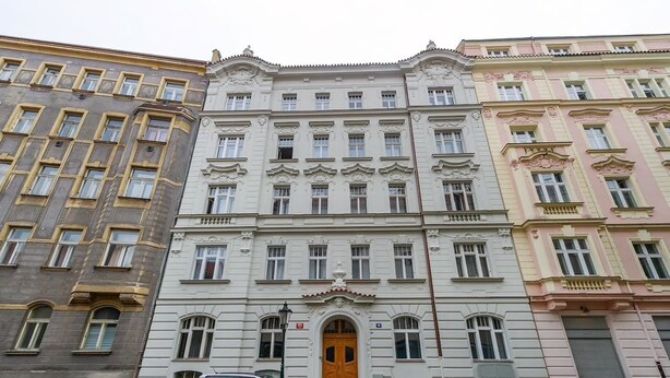 A multi-story building with a central entrance, flanked by two other buildings. - Central & Parking Assistance (Prague)