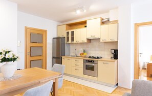 Enjoy cooking in this well-equipped kitchen with a refrigerator, stove, and coffee maker.