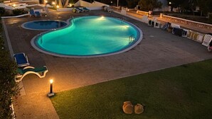 A swimming pool with two smaller pools, a grassy area, and a white building with arches. - Gin & Tonic Apartment in Son Parc with Pool, Padel Court, and Sea View near Son Saura Beach (Son Parc)