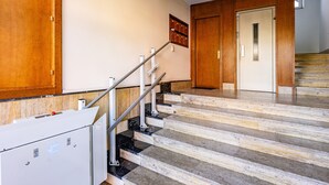 A staircase with a handrail, a wooden door, and a wall-mounted mailbox. - Apartment 'Comarca Del Sella' with Mountain View and Wi-Fi (Arriondas)