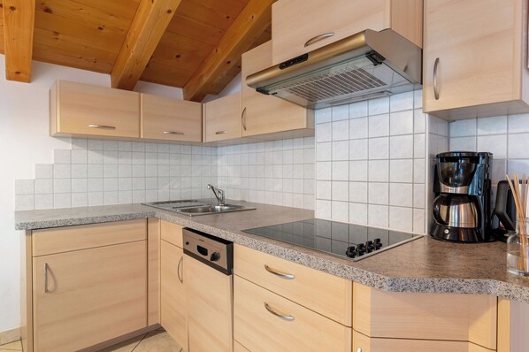 Fridge, stovetop, dishwasher, coffee/tea maker