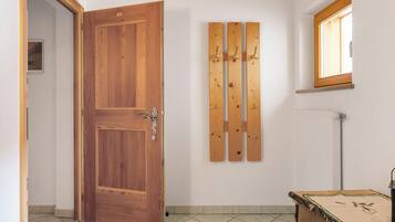 A wooden door, a radiator, and a window with a wooden frame.