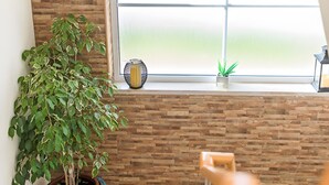 A room with a large window, a potted plant, and a staircase. - Holiday Home 'Laguna Formosa' with Private Terrace, Wi-Fi, SPA/Jacuzzi & Air Conditioning (Faro)