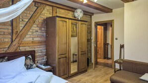 A bedroom with a bed, a wooden wardrobe, a nightstand, a bedside table, a lamp, and a chair. - 2 bedroom beautiful apartment in Obryta (Obryta)