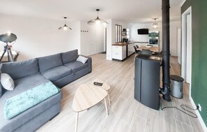 Cozy living space with a sofa, coffee table, and kitchen area.