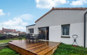 Enjoy outdoor dining or relaxation on the deck with a table and chairs.
