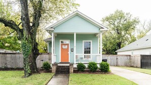 A single-story house with a front porch, a mailbox, and a number 318 sign.