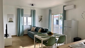 A modern living space with a dining area, a sofa, a ceiling fan, and a refrigerator. - Sea View Apt3 Finca TenDays Orotava with Wi-Fi and Air Conditioning (La Orotava)