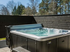 A rectangular hot tub with a light blue interior, set against a wooden wall. - 5 Star Holiday Home in Aakirkeby (Akirkeby)