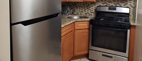 Fridge, microwave, cookware/dishes/utensils, dining tables