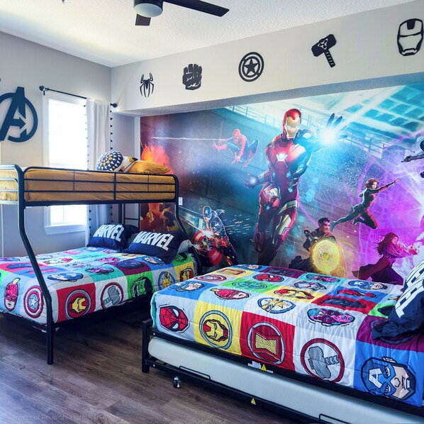 A bedroom with two bunk beds, each with a colorful superhero-themed bedspread. - Themed Luxury Apartment With Pools & Jacuzzi

REUNION RESORT: Gym & Restaurants (Kissimmee)