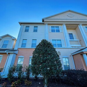A multi-story building with a symmetrical facade, large windows, and a central entrance. - Themed Luxury Apartment With Pools & Jacuzzi

REUNION RESORT: Gym & Restaurants (Kissimmee)