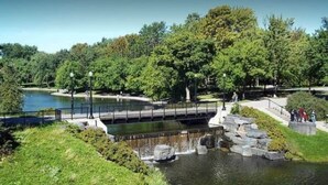 A park with a pond, a bridge, and a walking path. - Mont-Royal Ave Studio · Walk to La Fontaine Park (Montreal)