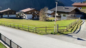 Una fila di edifici in stile chalet tradizionali, con tetti spioventi, in una zona montana sotto un cielo sereno.