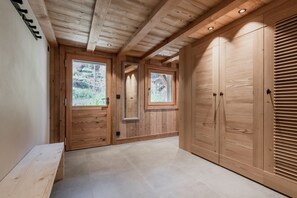 Stroll through this beautifully appointed hallway with a bench and large windows.