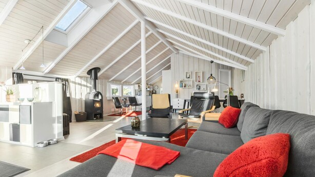 A spacious living area with a high ceiling, a fireplace, and a modern sofa with red cushions. - Gorgeous home in Grenaa with WiFi (Grenaa)