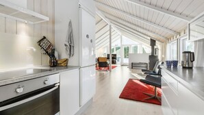 A modern kitchen with white cabinetry, a built-in oven, and a red rug. - Gorgeous home in Grenaa with WiFi (Grenaa)