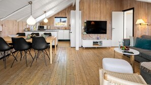 Un espacio habitable moderno estilo loft con cocina, comedor y zona de estar.