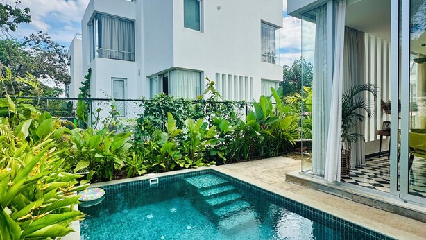 A modern house with a swimming pool surrounded by lush greenery. - Casa Bella Vita (Anjuna)