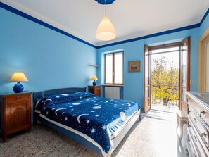 Relax in this serene bedroom with a starry night theme, featuring a comfortable bed, bedside tables, and a dresser.