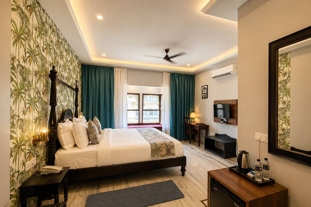 A hotel room with a bed, a desk, a television, and a minibar.
