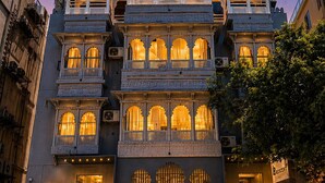 A multi-story building with balconies, a staircase, and a sign reading 'RESCENT.' - The Crescent Udaipur | Boutique Hotel Near Lake Pichola (Udaipur)