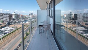 A balcony with a clear view of a marina and cityscape. - Apartment in Ostend near Marina & Park (OSTEND)