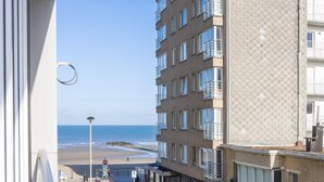 A high-rise building with multiple balconies overlooking a beach. - Modern flat near the sea (Middelkerke)
