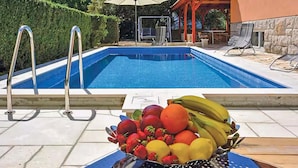 A swimming pool with a fruit bowl in the foreground. - Amazing home in Split with private swimming pool, can be inside or outside (Split)