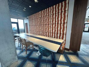 A modern interior with a long table, chairs, and a patterned wall. - 7 Combined units with Stunning City Views (Cleveland)