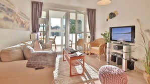 Ein modernes Wohnzimmer mit Sofa, Couchtisch und TV-Schrank.