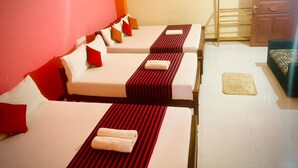 A hotel room with two beds, each with a red-striped bed runner and white pillows. - Cinnamon Tree (Anuradhapura)