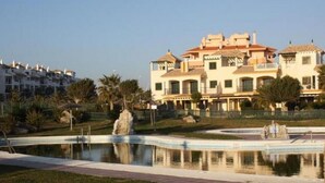 A large, multi-story building with a swimming pool and a fountain in the center. - Beachfront Apartments with Pool in Atlanterra, Zahara de los Atunes (Zahara de los Atunes)