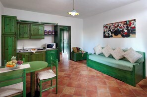 Cozy living space with a kitchenette, dining table, and comfortable seating area.