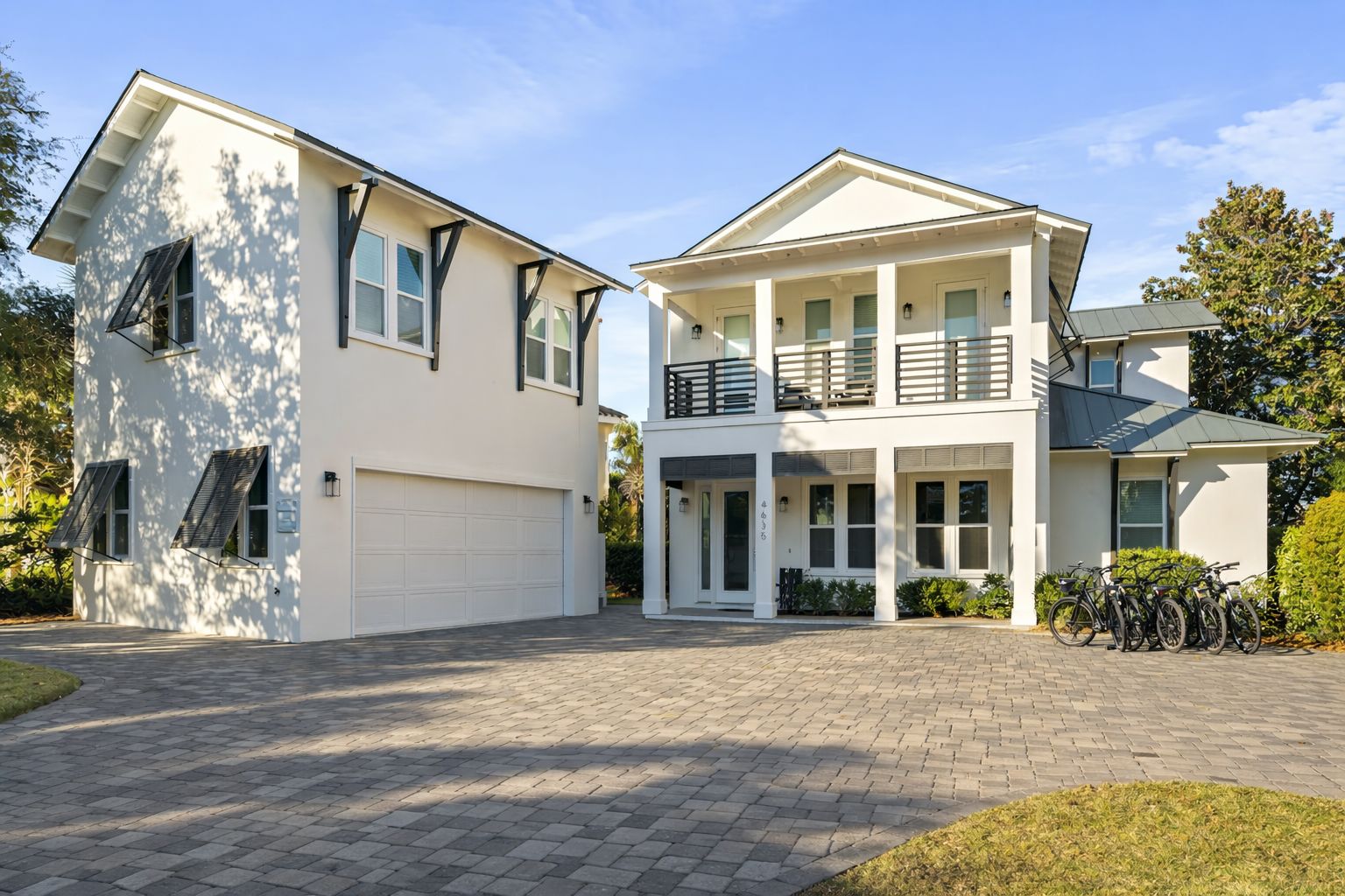 A two-story house with a garage, a balcony, and a driveway.