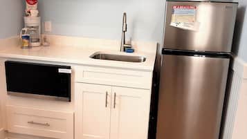 Fridge, microwave, coffee/tea maker, cookware/dishes/utensils