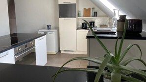 A compact kitchen with a black countertop, a small refrigerator, and a microwave. - La Canopée des Arbres Juliette! Relax and enjoy yourself at the edge of the forest! (Ellezelles)