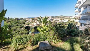 A residential area with a view of a town, surrounded by greenery and a clear sky. - REF 96 - Charming Apartment with Pool Near Beaches & Golf Courses (Mijas)