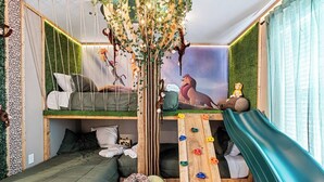 A children's playroom with a bunk bed, climbing wall, and a slide. - Brand New, Stylish Home 5B/4, 5B, Heated Pool & BBQ (Clermont)
