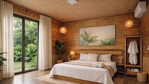A bedroom with a large bed, a view of greenery through a sliding door, a wall-mounted air conditioner, and a wooden ceiling. - Hidden Valley Eco Retreat Trang An (Ninh Binh)