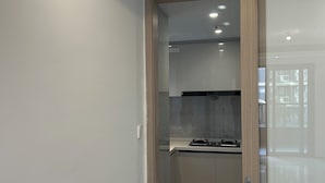 A modern kitchen with a built-in stove, cabinets, and a glass door leading to the dining area. - 3-bedroom, 2 bedroom, 1 livingroom, 1 kitchen with washer-dryer, WiFi, AC  (Shang Hai Shi)