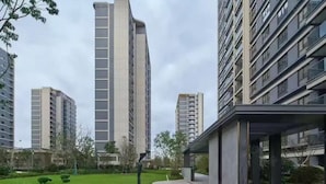 A modern residential building complex with high-rise apartments, a well-maintained lawn, and a covered walkway. - 3-bedroom, 2 bedroom, 1 livingroom, 1 kitchen with washer-dryer, WiFi, AC  (Shang Hai Shi)
