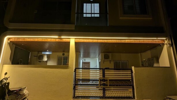 A two-story building with a gated entrance and a motorcycle parked outside.