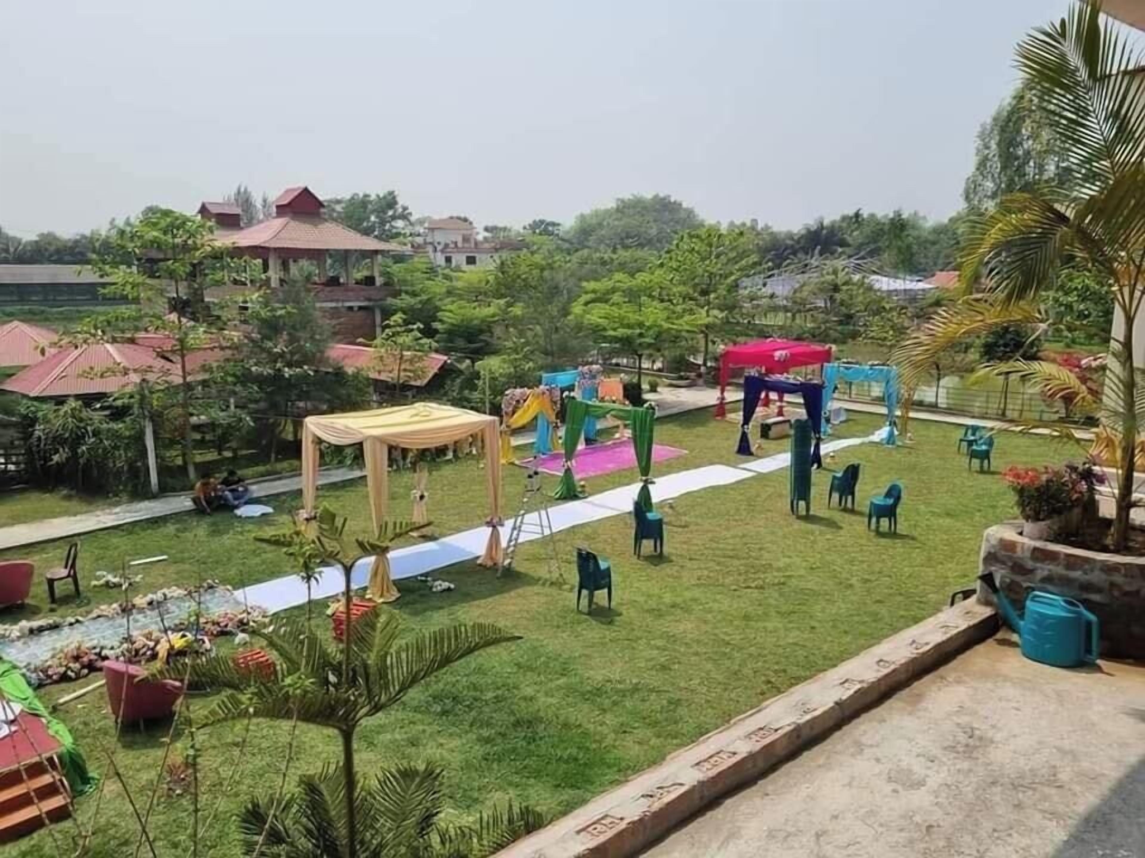 A courtyard with a grassy area, a wooden pergola, and a playground.