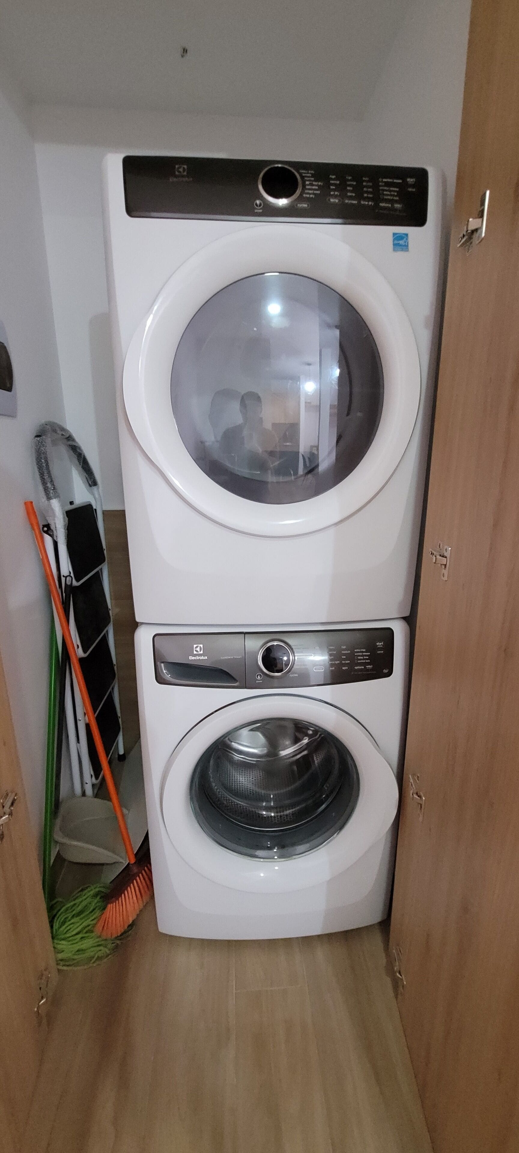 A stacked washer and dryer unit in a laundry room.