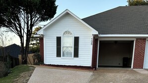 A residential driveway leading to a house with a garage. - The Tiled Waters Retreat (Brandon)
