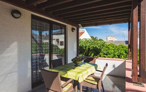 Enjoy a romantic meal for two on the patio, surrounded by lush greenery and a serene view.
