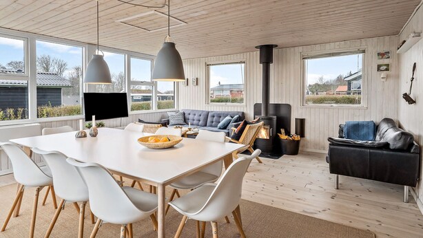 A modern interior with a dining area, sofa, and fireplace. - Gorgeous home in Juelsminde with WiFi (Juelsminde)