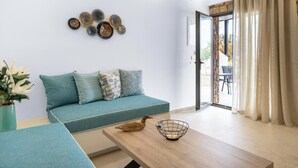 A modern living room with a teal sofa, a wooden coffee table, and decorative wall art.